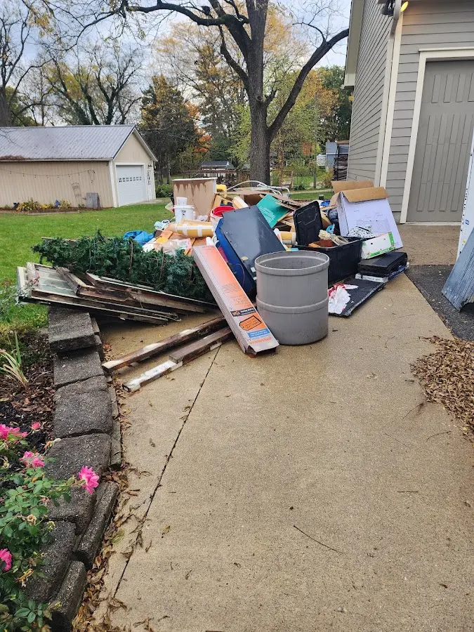 Dumpster being loaded with debris for Residential Dumpster Rental in Navarre